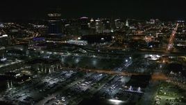 5.7K aerial stock footage reverse view of the skyline from arena parking lots at night, Downtown Buffalo, New York Aerial Stock Footage | DX0002_205_014
