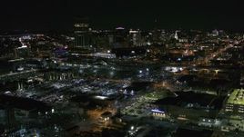 5.7K aerial stock footage reverse view of the skyline near arena parking lots at night, Downtown Buffalo, New York Aerial Stock Footage | DX0002_205_015