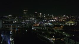 5.7K aerial stock footage of flying past the downtown skyline at night, reveal grain elevators, Downtown Buffalo, New York Aerial Stock Footage | DX0002_205_017