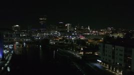 5.7K aerial stock footage of flying past grain elevator to reveal the downtown skyline at night, Downtown Buffalo, New York Aerial Stock Footage | DX0002_205_018