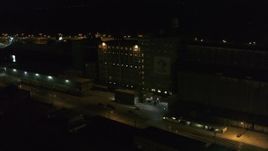 5.7K aerial stock footage slowly orbit flour mill at night, Buffalo, New York Aerial Stock Footage | DX0002_205_020