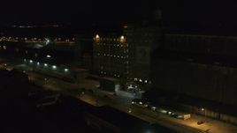 5.7K aerial stock footage orbit a flour mill at night, Buffalo, New York Aerial Stock Footage | DX0002_205_021
