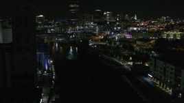 5.7K aerial stock footage of flying over the river toward the downtown skyline at night, Downtown Buffalo, New York Aerial Stock Footage | DX0002_205_024