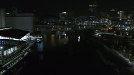 5.7K aerial stock footage of flying over the river toward the downtown skyline at night, Downtown Buffalo, New York Aerial Stock Footage | DX0002_205_025