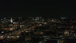 5.7K aerial stock footage of a view across downtown at distant Buffalo General Medical Center at night, Downtown Buffalo, New York Aerial Stock Footage | DX0002_205_040