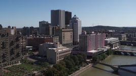 5.7K aerial stock footage approach riverfront hotels and the city's skyline, Downtown Rochester, New York Aerial Stock Footage | DX0002_206_001