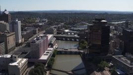 5.7K aerial stock footage reverse view of riverfront hotel across from office building, Downtown Rochester, New York Aerial Stock Footage | DX0002_206_008