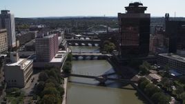 5.7K aerial stock footage ascend toward riverfront hotel across from office building, Downtown Rochester, New York Aerial Stock Footage | DX0002_206_009