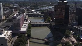 5.7K aerial stock footage fly away from riverfront hotel across from office building, Downtown Rochester, New York Aerial Stock Footage | DX0002_206_010