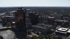 5.7K aerial stock footage descend with view of office buildings and hotel by the Genessee River, Downtown Rochester, New York Aerial Stock Footage | DX0002_206_014