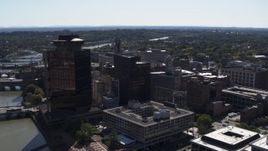 5.7K aerial stock footage orbit office buildings and hotel by the Genessee River, Downtown Rochester, New York Aerial Stock Footage | DX0002_206_015