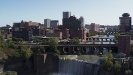 5.7K aerial stock footage fly over falls and bridges to toward the city's skyline, Downtown Rochester, New York Aerial Stock Footage | DX0002_206_032