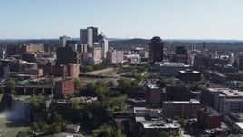 5.7K aerial stock footage of flying by High Falls, Genesee River and skyline, Downtown Rochester, New York Aerial Stock Footage | DX0002_206_039