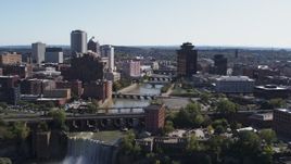 5.7K aerial stock footage of flying over High Falls toward Genesee River bridges and skyline, Downtown Rochester, New York Aerial Stock Footage | DX0002_206_040