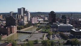 5.7K aerial stock footage of passing Genesee River bridges and office tower, Downtown Rochester, New York Aerial Stock Footage | DX0002_206_041