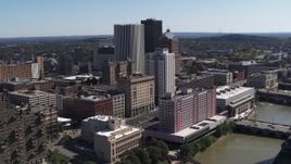 5.7K aerial stock footage of skyline and river seen while ascending by apartment complex, Downtown Rochester, New York Aerial Stock Footage | DX0002_206_044