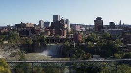 5.7K aerial stock footage fly away from skyline and bridges near the falls, Downtown Rochester, New York Aerial Stock Footage | DX0002_207_001