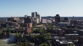 5.7K aerial stock footage descend past skyline and river bridges to reveal High Falls, Downtown Rochester, New York Aerial Stock Footage | DX0002_207_008