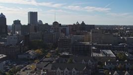 5.7K aerial stock footage descend and pass by office buildings and parking garage, Downtown Rochester, New York Aerial Stock Footage | DX0002_208_018