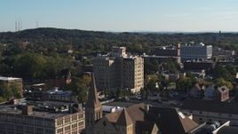 5.7K aerial stock footage flying away from office building, reveal church in Rochester, New York Aerial Stock Footage | DX0002_208_029