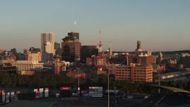 5.7K aerial stock footage circling a radio tower near First Federal Plaza at sunset, Downtown Rochester, New York Aerial Stock Footage | DX0002_209_034