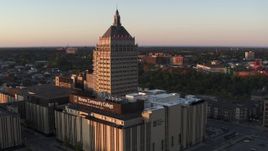 5.7K aerial stock footage fly away from college and Kodak Tower at sunset, Rochester, New York Aerial Stock Footage | DX0002_209_036
