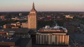 5.7K aerial stock footage of a reverse view of a college and Kodak Tower at sunset, Rochester, New York Aerial Stock Footage | DX0002_209_038