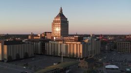 5.7K aerial stock footage descend away from Kodak Tower and a college at sunset, Rochester, New York Aerial Stock Footage | DX0002_209_040