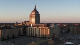 5.7K aerial stock footage ascending toward Kodak Tower and a college at sunset, Rochester, New York Aerial Stock Footage | DX0002_209_041
