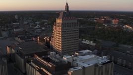 5.7K aerial stock footage stationary view of Kodak Tower and a college at sunset, Rochester, New York Aerial Stock Footage | DX0002_209_042