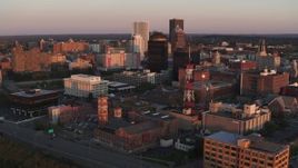 5.7K aerial stock footage focus on First Federal Plaza while passing a radio tower at sunset, Downtown Rochester, New York Aerial Stock Footage | DX0002_209_043