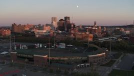 5.7K aerial stock footage ascend by baseball stadium to approach radio tower at sunset, Downtown Rochester, New York Aerial Stock Footage | DX0002_209_045