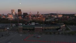 5.7K aerial stock footage fly away from office buildings and radio tower at sunset, reveal stadium, Downtown Rochester, New York Aerial Stock Footage | DX0002_209_046