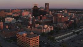 5.7K aerial stock footage of orbiting a radio tower and office buildings at sunset, Downtown Rochester, New York Aerial Stock Footage | DX0002_209_049