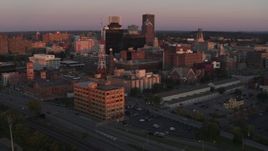 5.7K aerial stock footage of an orbit of a radio tower and office buildings at sunset, Downtown Rochester, New York Aerial Stock Footage | DX0002_209_050
