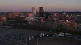 5.7K aerial stock footage reverse view of a radio tower and office buildings at sunset, Downtown Rochester, New York Aerial Stock Footage | DX0002_209_051