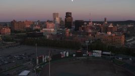5.7K aerial stock footage of flying by a radio tower and office buildings at sunset, Downtown Rochester, New York Aerial Stock Footage | DX0002_209_052