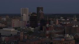 5.7K aerial stock footage descend and focus on Legacy Tower at twilight while passing radio tower, Downtown Rochester, New York Aerial Stock Footage | DX0002_210_008