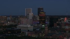 5.7K aerial stock footage of flying by the city skyline behind First Federal Plaza at twilight, Downtown Rochester, New York Aerial Stock Footage | DX0002_210_019