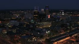 5.7K aerial stock footage descend and fly away from the city's skyline at night, Downtown Rochester, New York Aerial Stock Footage | DX0002_210_023