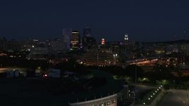 5.7K aerial stock footage reverse view of office buildings, reveal stadium at night, Downtown Rochester, New York Aerial Stock Footage | DX0002_210_026