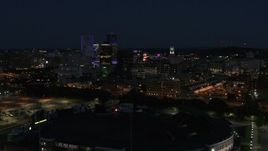 5.7K aerial stock footage of descending toward office buildings and skyline at night, Downtown Rochester, New York Aerial Stock Footage | DX0002_210_031
