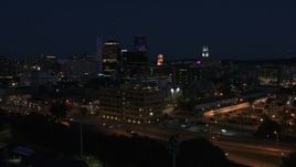 5.7K aerial stock footage descend while focused on office buildings at night, Downtown Rochester, New York Aerial Stock Footage | DX0002_210_032