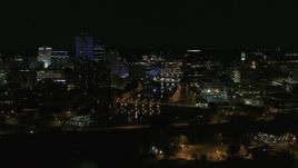 5.7K aerial stock footage of the Genesee River and skyline seen during ascent at night, Downtown Rochester, New York Aerial Stock Footage | DX0002_210_038