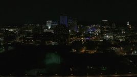 5.7K aerial stock footage of a view of the city's skyline, the Genesee River, and High Falls at night, Downtown Rochester, New York Aerial Stock Footage | DX0002_210_049