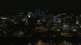 5.7K aerial stock footage of a reverse view of the Genesee River and skyline at night, Downtown Rochester, New York Aerial Stock Footage | DX0002_210_051