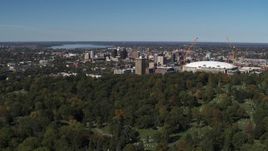5.7K aerial stock footage of Carrier Dome and Downtown Syracuse, New York seen from cemetery Aerial Stock Footage | DX0002_211_004