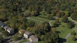 5.7K aerial stock footage fly away from graves at Morningside Cemetery near homes  in Syracuse, New York Aerial Stock Footage | DX0002_211_006