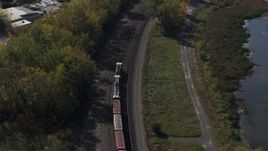 5.7K aerial stock footage track a train on the shore of a lake in Syracuse, New York Aerial Stock Footage | DX0002_211_031
