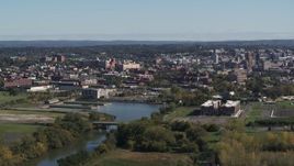 5.7K aerial stock footage of an apartment complex beside Onondaga Creek, Downtown Syracuse in background, New York Aerial Stock Footage | DX0002_211_037